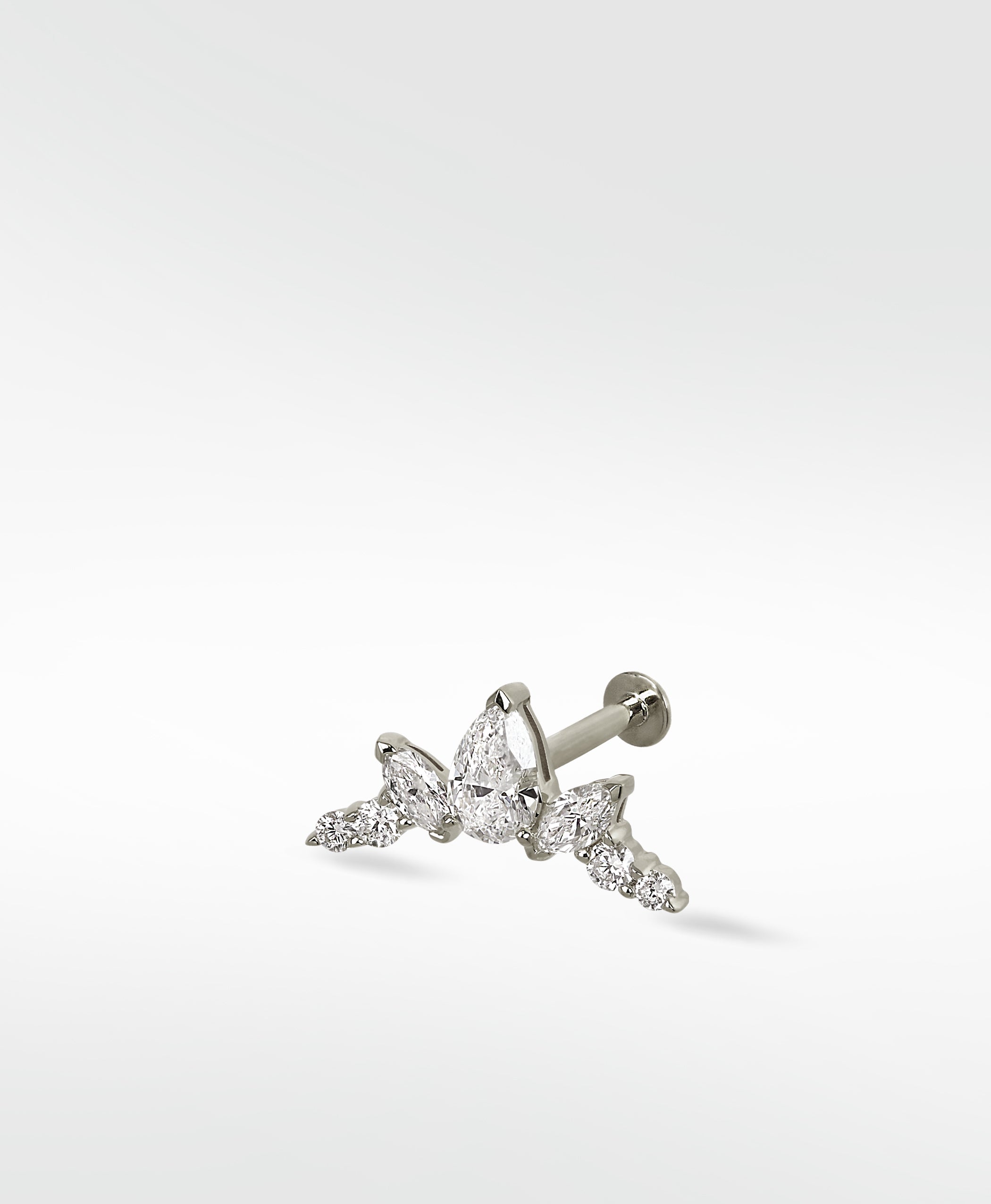 The white gold Crown Crawler earring featuring a cluster of brilliant pear, marquise, and round cut diamonds.